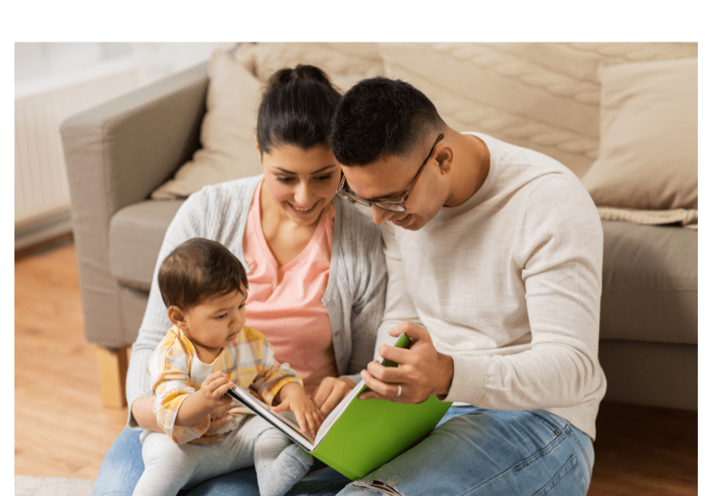 A man and woman reading to a baby.