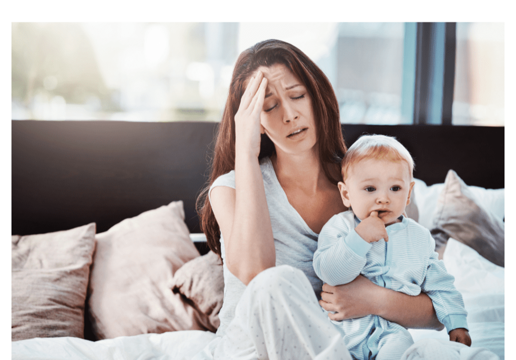 A woman holding her baby and touching their forehead.